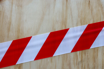 red and white striped barrier tape on wall