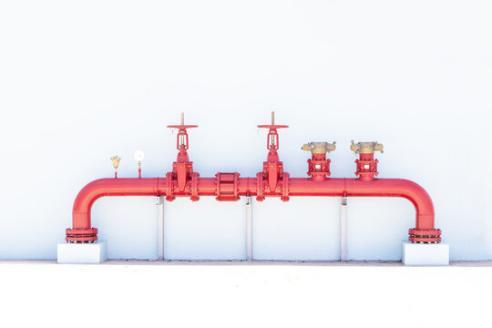 A row of red color fire fighting water sprinkler supply pipeline system. Used in large industrial applications