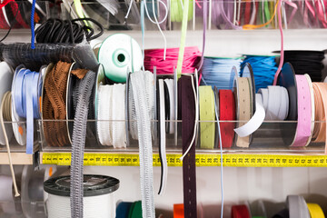 Colorful ribbons, webbing, braid, bias tapes, cords for sewing or needlecraft on store showcase