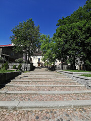 A large, wide, stone staircase in the park on a sunny summer day in Vyborg.