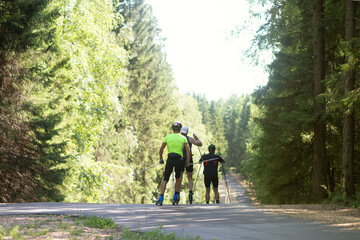 Obraz premium A man on a roller ski rides in the park.Cross country skilling.