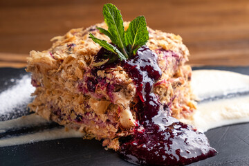 Napoleon cake with sauce. Closeup