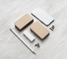 Smartphone and blank stationery set: kraft business cards, pencil and eraser.