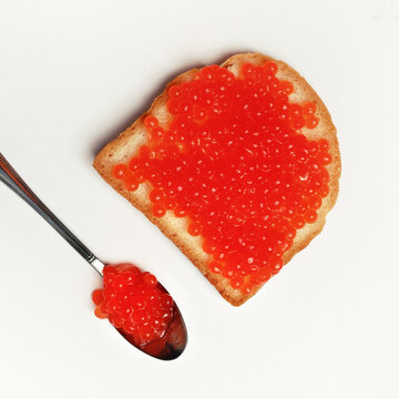 Red caviar, sandwich and spoon. Top view. Flat lay.