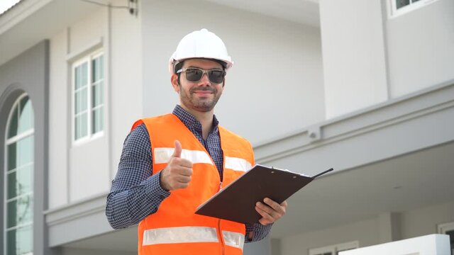 architect  holding clipboard  checking list and audit on construction site at village show thumps up and looking camera . foreman worker Inspection home
