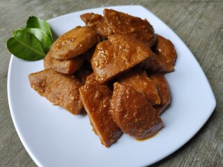 Semur jengkol or jengkol stew on a white plate. one of Indonesia's favorite foods.