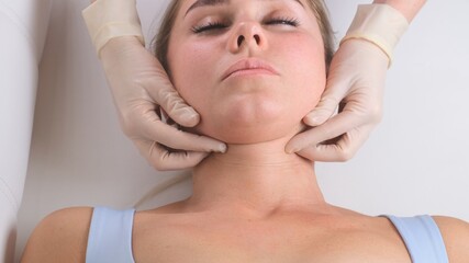 Chin massage of woman young woman during face massage at beauty salon