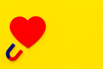 Love and relashionship concept. Horseshoe magnet with heart shapes