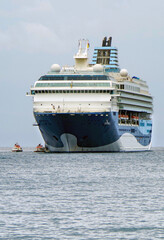 Modern Marella cruiseship cruise ship liner Explorer 2 anchoring offshore at sea on cloudy day with tender boats and horizon view	during Greek Island cruising