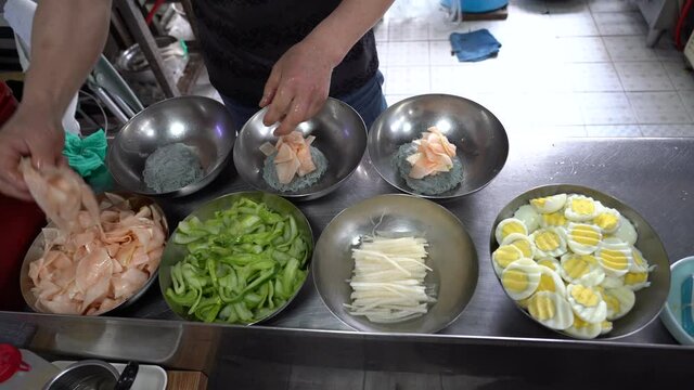 Korean cold noodles; naengmyeon. Sliced cucumber, pickled radish. savory food