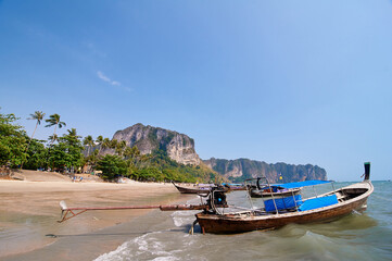 Travel by Thailand. Landscape with traditional longtail fishing boats on the sea beach.