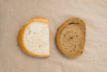 two slices of white bread and rye gray bread. comparison of the bread variety. gluten-free product