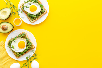 Toasts with avocado and fried eggs. Healthy breakfast
