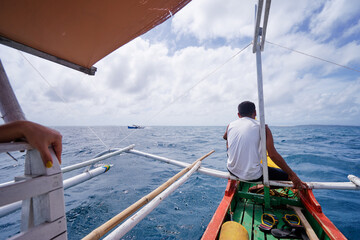 Vacation in Philippines. Sailing the sea on traditional boat.