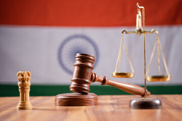Concept of Indian justice system showing by using Judge Gavel, Balance scale on Indian flag as...