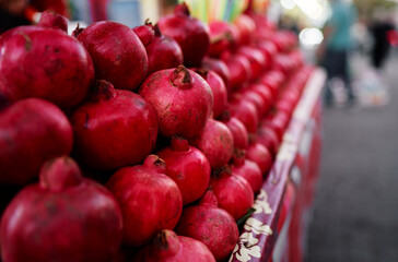 Fresh fruits. Red pomegranates on the street market.