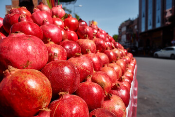 Fresh fruits. Red pomegranates on the street market.