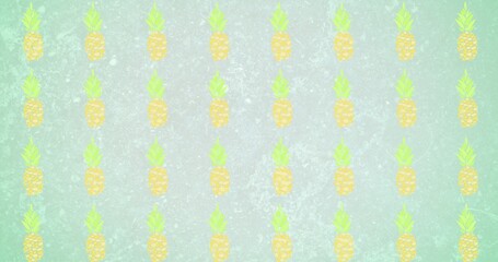 Composition of rows of pineapples on green background
