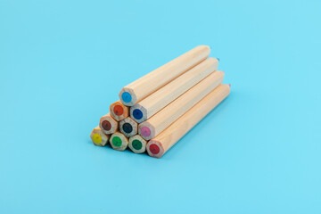 Wooden colorful ordinary pencils isolated on blue background
