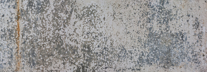 Rough wall texture with peeling paint. Gray background, grunge.