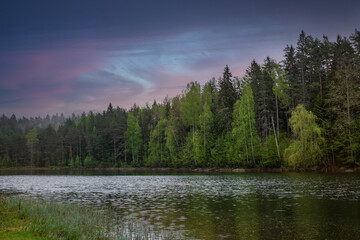 Fototapeta na wymiar Jouga lake (Estonian - Jõuga järv) on a cloudy summer evening. Dramatic sky in the background.