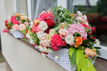 Flower arrangement in a basket. Flower decoration of events, floristry, natural beauty, holidays