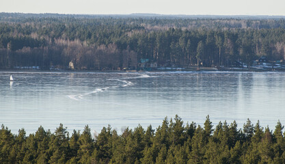 Aerial view of Usma lake in sunny winter evening without snow, Latvia.