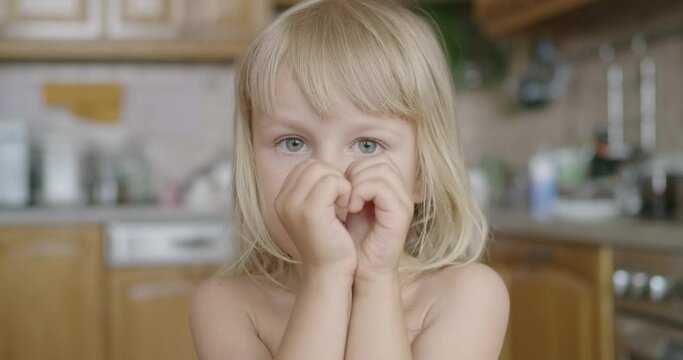 little girl make heart