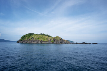 Seascape. Travel by Thailand. Green rock island.