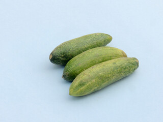 fresh raw green cucumbers on a plain table background