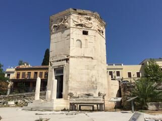 Fototapeta na wymiar The Tower of the Winds is an octagonal Pentelic marble clocktower in the Roman Agora in Athens that functioned as a horologion or 