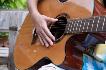 girl playing classical guitar