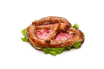Pretzel with salami and lettuce isolated on a white background.