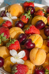 Background from fresh berries and fruits - apricots, strawberries, cherries close-up