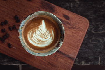 Selective focus cup of hot latte art coffee,focus at white foam