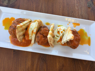 Traditional meatballs, pita, spicy tomato and yogurt-dill sauce served in Athens, Greece