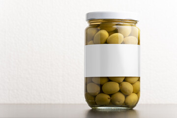 Green olives conserve with round cap on white background, editable mock-up series template