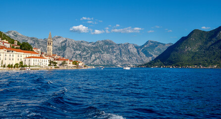 Scenic panorama view of the historic town of Perast. View across Bay of Kotor from shuttle boat. Montenegro, Europe.
