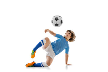 Portrait of little male football soccer player, boy training with football ball isolated on white studio background. Concept of sport, game, hobby