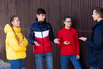Teenage friends spend time together in city streets in spring. Vacation and teens concept