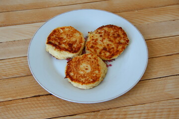 Homemade cheesecakes on a plate on the wooden background