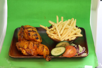 Chicken And Chips served with salad on a plate