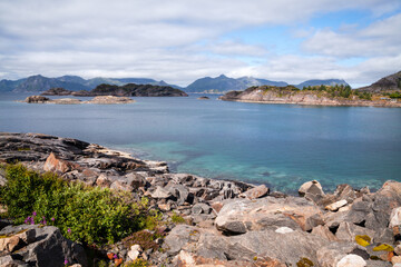 A rocky shoreline and several islands at horizon at fjord near Lofoten islands, Norway.