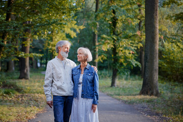 Senior family couple walking together at summer park.