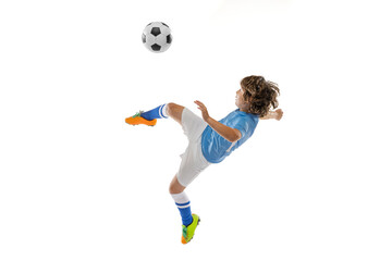 Fototapeta na wymiar Young male football soccer player, boy training with football ball isolated on white studio background. Concept of sport, game, hobby