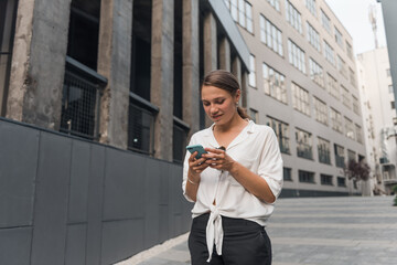 Woman walking, text messaging, thinking and replying on smartphone. Business woman text messaging...