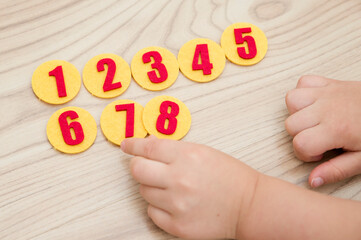 Sequence of Numbers from one to seven. Kids hand holding number. Children toy for learning numbers...