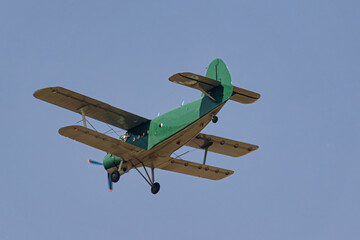 Light-engine propeller biplane aircraft AN-2 flying in the sky. View from the ground