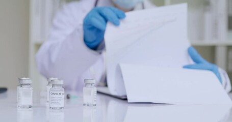 Doctor reading files of register patient data of Covid-19 vaccine - Powered by Adobe