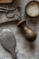 old cutlery wood spoon knives scissors jar bowls on gray background